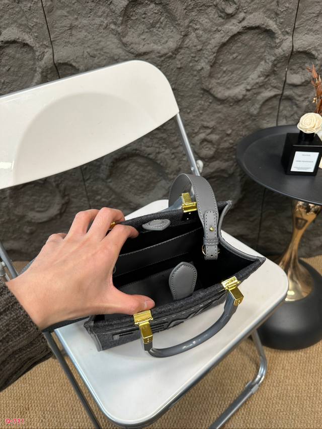 Fendi woolen mini tote bag of the same price, printed with brown ff jacquard pattern and light brown leather Fendi Roma logo, with hard leather handle. Featuring spacious interior compartments with light brown leather edges and gold accents: