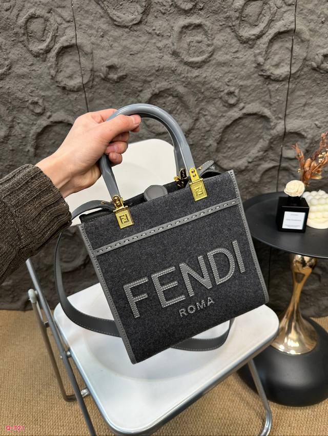 Fendi woolen mini tote bag of the same price, printed with brown ff jacquard pattern and light brown leather Fendi Roma logo, with hard leather handle. Featuring spacious interior compartments with light brown leather edges and gold accents: