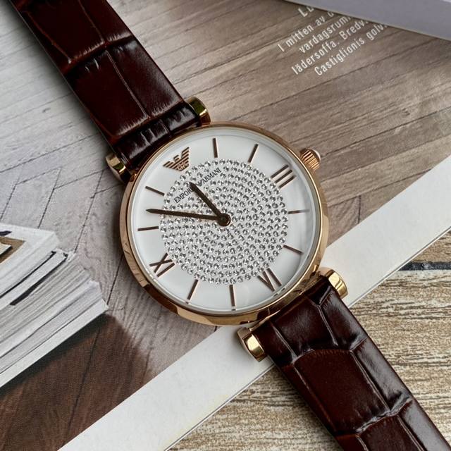 Original order new to Armani quartz women's watch. Versatile and stunning, with a starry dial that sparkles with extraordinary brilliance. Paired with a double needle design and a calf leather strap, the delicate grain adds an elegant and fashionable