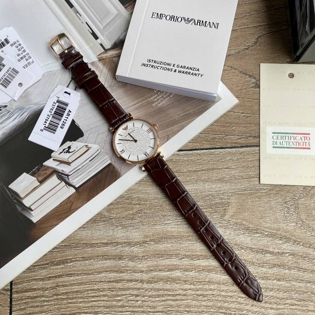 Original order new to Armani quartz women's watch. Versatile and stunning, with a starry dial that sparkles with extraordinary brilliance. Paired with a double needle design and a calf leather strap, the delicate grain adds an elegant and fashionable